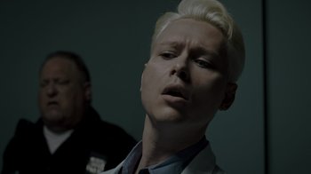 Movie still from “Amityville Uprising” (2022), directed by Thomas J. Churchill – A man with blonde hair is looking up; Close Up shot, Low angle