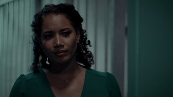 Movie still from “Amityville Uprising” (2022), directed by Thomas J. Churchill – A person wearing a green shirt; Close Up shot, Over the shoulder angle