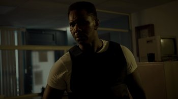 Movie still from “Amityville Uprising” (2022), directed by Thomas J. Churchill – A man in a white shirt and a black vest; Close Up shot, Low angle