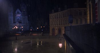 Movie still from “An American Werewolf in Paris” (1997), directed by Anthony Waller – A view of a city street at night with lights on; Extreme Wide shot, High angle