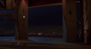 Movie still from “An American Werewolf in Paris” (1997), directed by Anthony Waller – A view of a city at night from a bridge; Extreme Wide shot, High angle