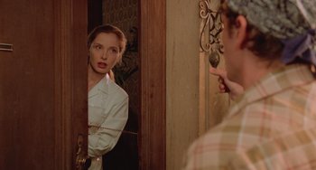 Movie still from “An American Werewolf in Paris” (1997), directed by Anthony Waller – A woman is looking at herself in the mirror; Medium shot, Over the shoulder angle