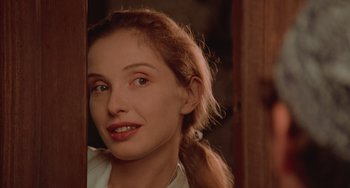 Movie still from “An American Werewolf in Paris” (1997), directed by Anthony Waller – A woman with a ponytail looking into a mirror; Close Up shot, Over the shoulder angle