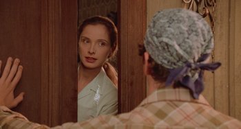 Movie still from “An American Werewolf in Paris” (1997), directed by Anthony Waller – A woman looking in the mirror while a man looks at her face; Close Up shot, Over the shoulder angle
