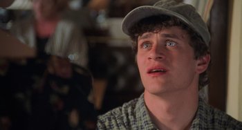 Movie still from “An American Werewolf in Paris” (1997), directed by Anthony Waller – A person wearing a hat; Close Up shot, Over the shoulder angle
