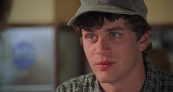 Movie still from “An American Werewolf in Paris” (1997), directed by Anthony Waller – A person wearing a hat; Close Up shot, Over the shoulder angle