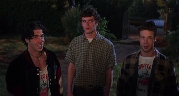 Movie still from “An American Werewolf in Paris” (1997), directed by Anthony Waller – A group of people standing next to each other in the dark; Medium shot, Low angle