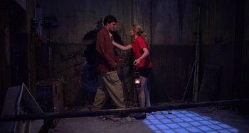 Movie still from “An American Werewolf in Paris” (1997), directed by Anthony Waller – A man and a woman standing next to each other; Wide shot, Low angle