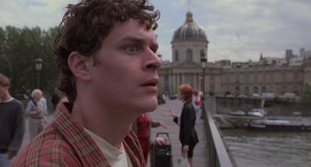 Movie still from “An American Werewolf in Paris” (1997), directed by Anthony Waller – A young man looking into the distance on a bridge; Close Up shot, Low angle