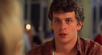 Movie still from “An American Werewolf in Paris” (1997), directed by Anthony Waller – A person wearing a plaid shirt; Close Up shot, Over the shoulder angle