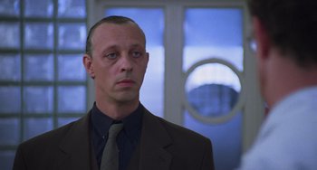 Movie still from “An American Werewolf in Paris” (1997), directed by Anthony Waller – A person wearing a suit and a tie; Close Up shot, Low angle