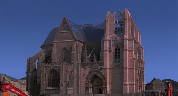Movie still from “An American Werewolf in Paris” (1997), directed by Anthony Waller – An old building with a large window in the middle of it; Extreme Wide shot, Low angle