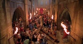 Movie still from “An American Werewolf in Paris” (1997), directed by Anthony Waller – A crowd of people in a church with lit torches; Extreme Wide shot, High angle
