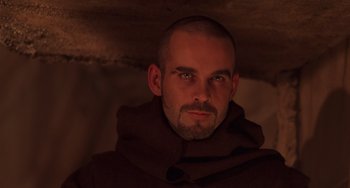 Movie still from “An American Werewolf in Paris” (1997), directed by Anthony Waller – A person wearing a monk's robe; Close Up shot, High angle