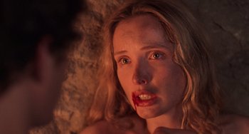 Movie still from “An American Werewolf in Paris” (1997), directed by Anthony Waller – A young woman with red lipstick on her mouth; Close Up shot, Over the shoulder angle