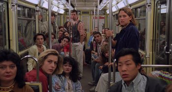 Movie still from “An American Werewolf in Paris” (1997), directed by Anthony Waller – A group of people sitting on top of a train; Wide shot, High angle