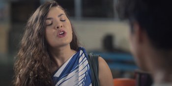Movie still from “An Unforgettable Year: Summer” (2023), directed by Cris D'Amato – A beautiful young lady with her eyes closed; Close Up shot, Over the shoulder angle