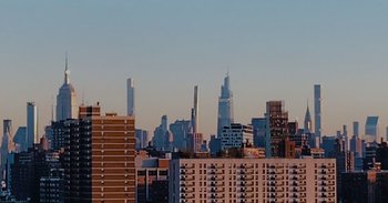 Movie still from “And Just Like That... The Documentary” (2022), directed by Fabien Constant – A view of a city skyline from a distance; Extreme Wide shot, Low angle