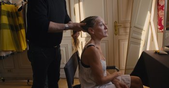 A woman sitting in a chair getting her hair done