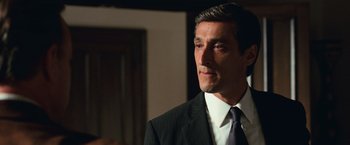 Movie still from “Angels & Demons” (2009), directed by Ron Howard – A person wearing a suit and tie; Close Up shot, Over the shoulder angle