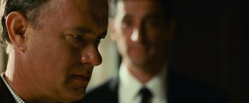 Movie still from “Angels & Demons” (2009), directed by Ron Howard – A man in a suit and tie next to another man in a suit and tie; Close Up shot, Over the shoulder angle