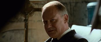 Movie still from “Angels & Demons” (2009), directed by Ron Howard – An older man in a suit and tie; Close Up shot, Low angle