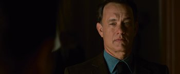 Movie still from “Angels & Demons” (2009), directed by Ron Howard – A man in a suit and tie looking at the camera; Close Up shot, Over the shoulder angle