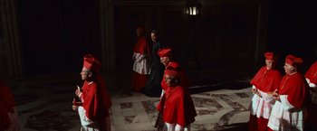 Movie still from “Angels & Demons” (2009), directed by Ron Howard – A group of men in red robes and red hats; Wide shot, High angle
