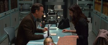 Movie still from “Angels & Demons” (2009), directed by Ron Howard – A man and a woman sitting at a table; Medium shot, Over the shoulder angle