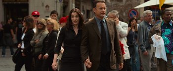 Movie still from “Angels & Demons” (2009), directed by Ron Howard – A man and a woman holding hands while walking down a street; Medium shot, Over the shoulder angle