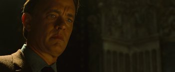 Movie still from “Angels & Demons” (2009), directed by Ron Howard – A man in a black shirt is looking at the camera; Close Up shot, Low angle