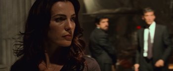 Movie still from “Angels & Demons” (2009), directed by Ron Howard – A person in a room with a man in a suit; Close Up shot, Over the shoulder angle