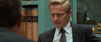 Movie still from “Angels & Demons” (2009), directed by Ron Howard – A person wearing a suit and tie; Close Up shot, Over the shoulder angle