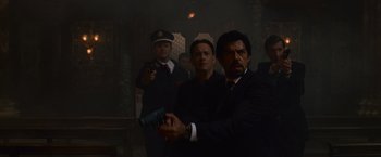 Movie still from “Angels & Demons” (2009), directed by Ron Howard – A group of men standing next to each other holding guns; Medium shot, Low angle