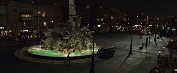 Movie still from “Angels & Demons” (2009), directed by Ron Howard – A fountain in the middle of a city at night; Extreme Wide shot, High angle