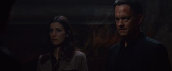 Movie still from “Angels & Demons” (2009), directed by Ron Howard – A man and a woman standing next to each other in the dark; Close Up shot, Over the shoulder angle