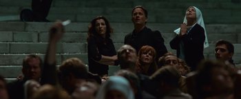 Movie still from “Angels & Demons” (2009), directed by Ron Howard – A man and a woman are standing in front of a group of people; Medium shot, High angle