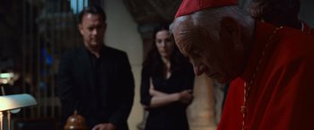 Movie still from “Angels & Demons” (2009), directed by Ron Howard – Two men and a woman standing next to each other in a room; Close Up shot, Over the shoulder angle