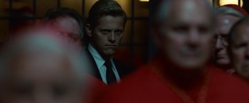 Movie still from “Angels & Demons” (2009), directed by Ron Howard – A man in a suit and a tie; Close Up shot, Over the shoulder angle