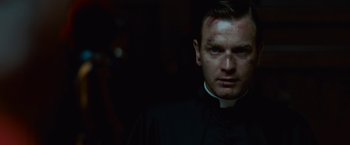 Movie still from “Angels & Demons” (2009), directed by Ron Howard – A man wearing a priest's outfit looking at the camera; Close Up shot, Low angle