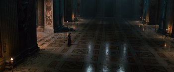 Movie still from “Angels & Demons” (2009), directed by Ron Howard – A person is standing in a room with candles; Extreme Wide shot, High angle