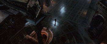 Movie still from “Angels & Demons” (2009), directed by Ron Howard – A person standing in a room with lights on the floor; Extreme Wide shot, High angle