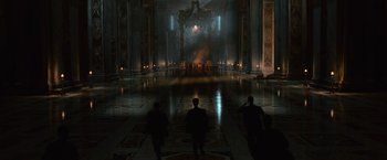 A group of people walking through a large room