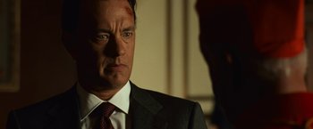Movie still from “Angels & Demons” (2009), directed by Ron Howard – A man in a suit and tie looking at the camera; Close Up shot, Over the shoulder angle