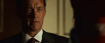 Movie still from “Angels & Demons” (2009), directed by Ron Howard – A man in a suit and tie looking at the camera; Close Up shot, Over the shoulder angle