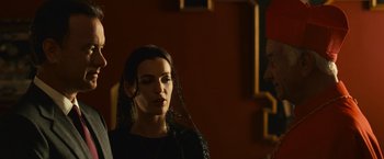 Movie still from “Angels & Demons” (2009), directed by Ron Howard – A woman wearing a black veil in front of a red wall; Close Up shot, Over the shoulder angle