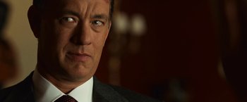 Movie still from “Angels & Demons” (2009), directed by Ron Howard – A person wearing a suit and tie; Close Up shot, Over the shoulder angle