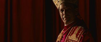 Movie still from “Angels & Demons” (2009), directed by Ron Howard – A man wearing a red robe and a gold hat; Close Up shot, Low angle
