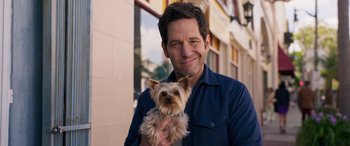 Movie still from “Ant-Man and the Wasp: Quantumania” (2023), directed by Peyton Reed – A man holding a small dog in his arms; Close Up shot, Over the shoulder angle