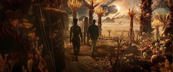 Movie still from “Ant-Man and the Wasp: Quantumania” (2023), directed by Peyton Reed – A group of people walking through a field; Extreme Wide shot, High angle